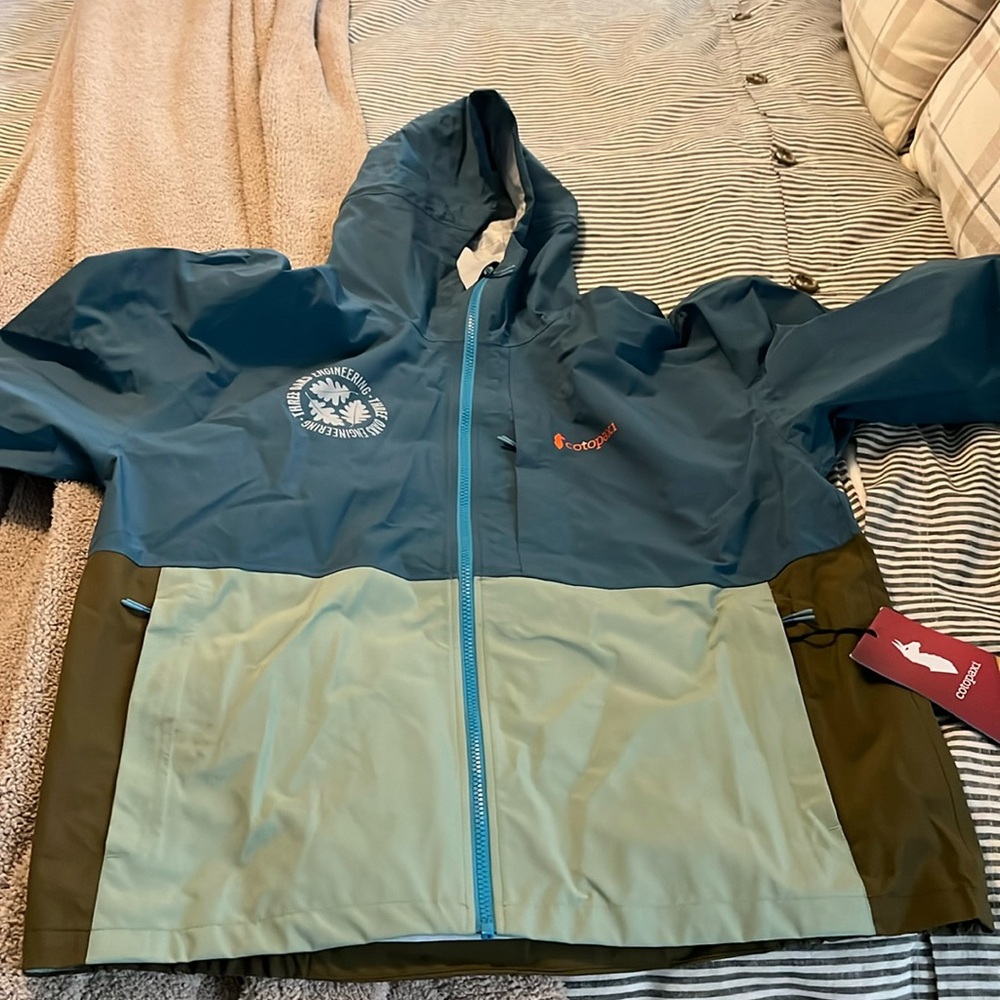 Brand new Cotopaxi rain jacket Men’s Large Blue Spruce